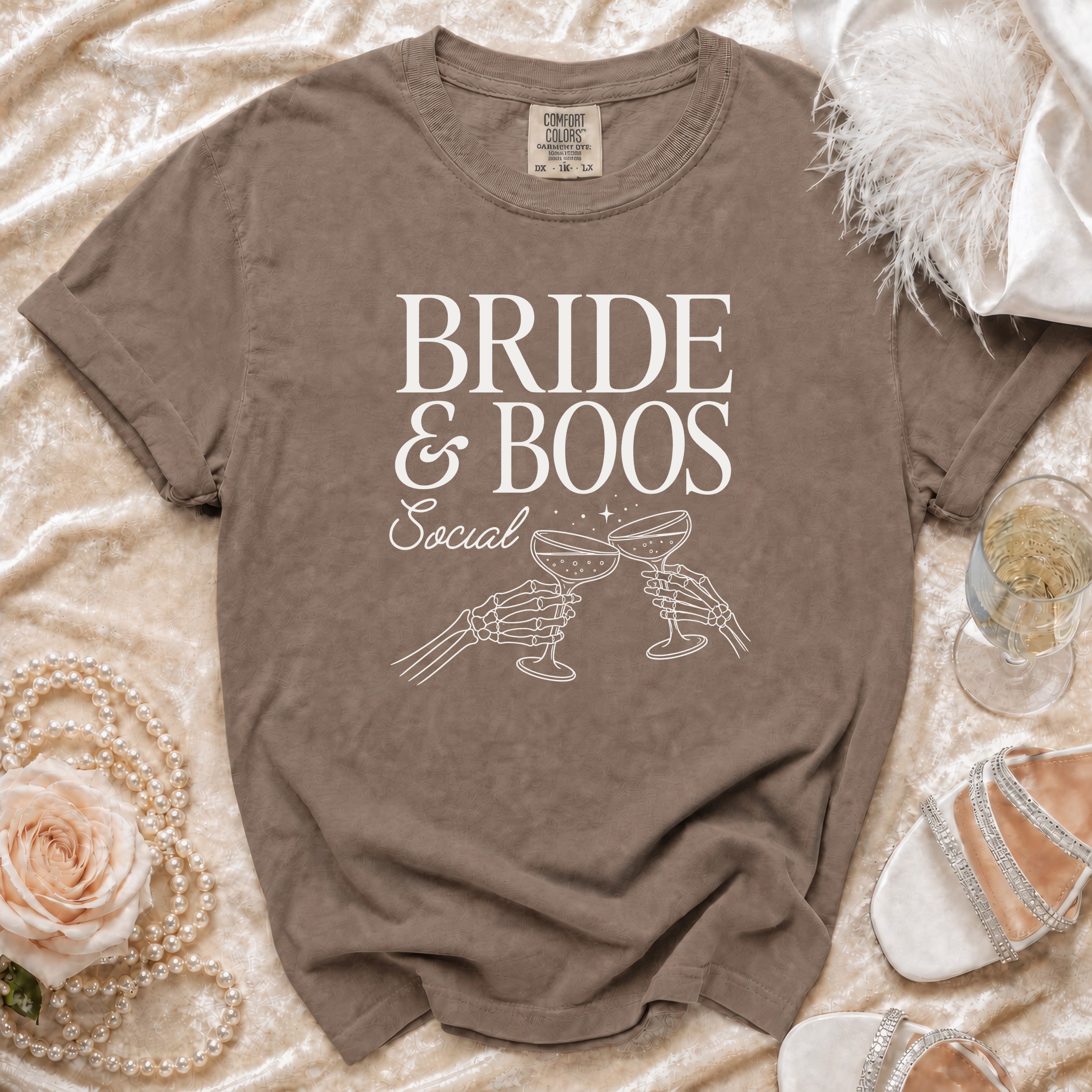 T-shirt with "Bride & Boos Social" text and skeleton hands clinking glasses.