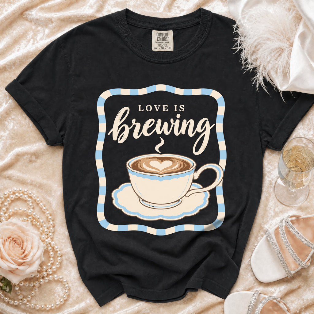 Black t-shirt with "Love is brewing" text and a coffee cup graphic.