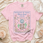 Pink t-shirt with "Reckless in Texas Olivia's Bach Austin, TX Summer 2026" design.