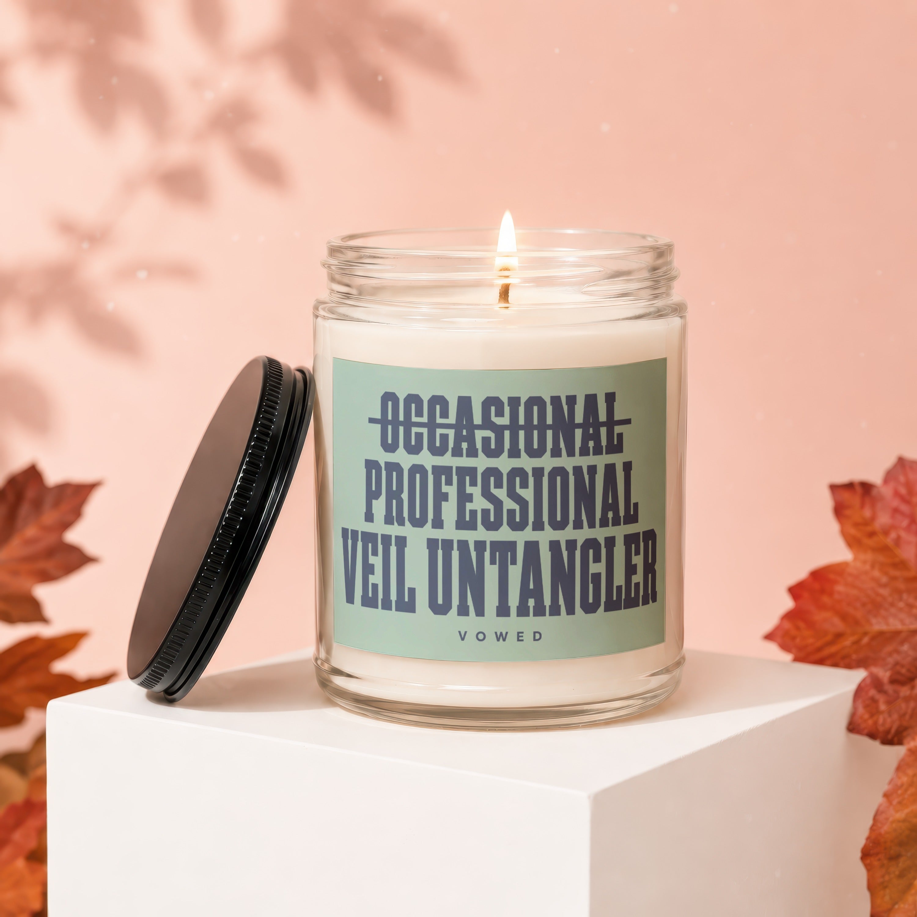 Candle with label reading "OCCASIONAL PROFESSIONAL VEIL UNTANGLER"