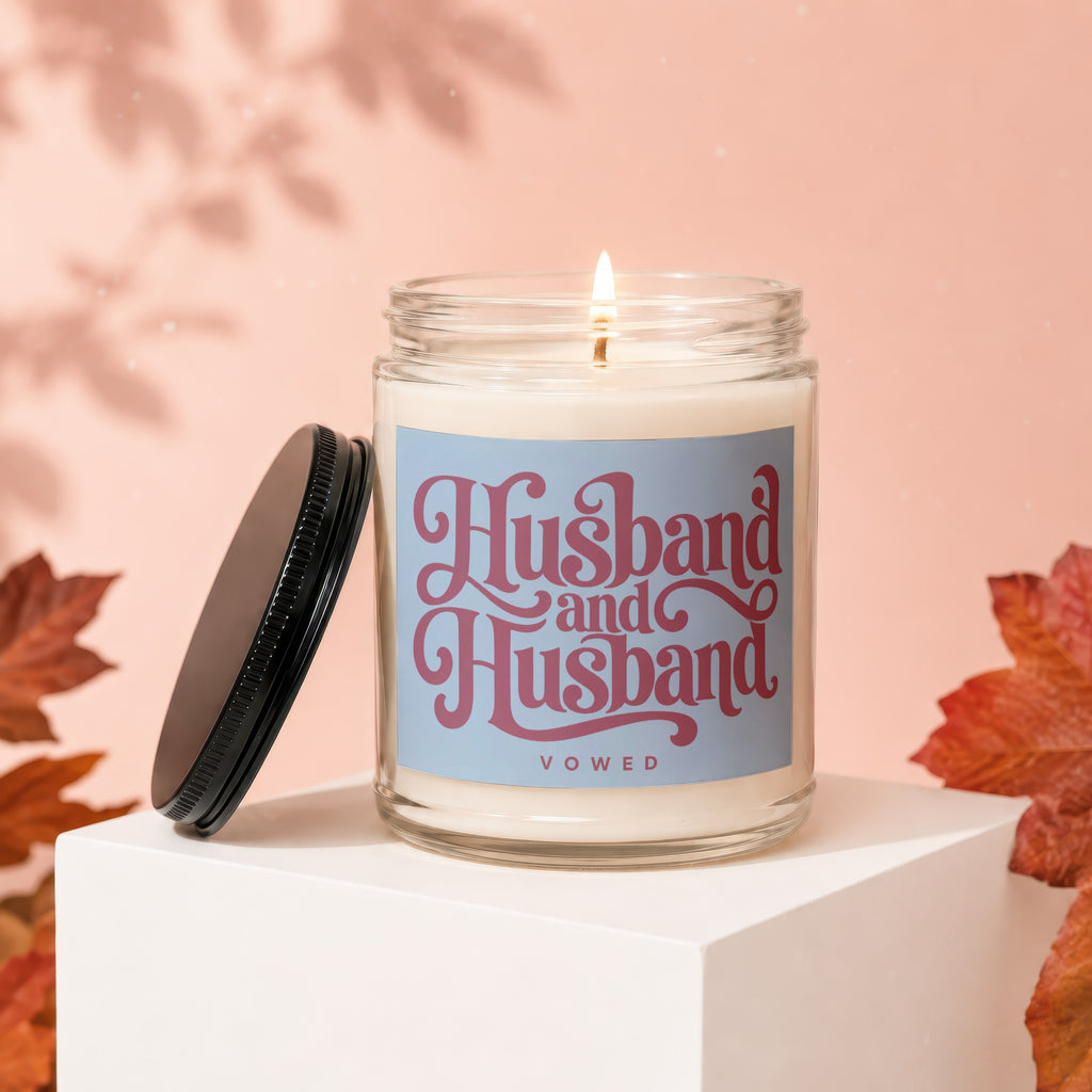 Glass candle with "Husband and Husband Vowed" text and burning wick.