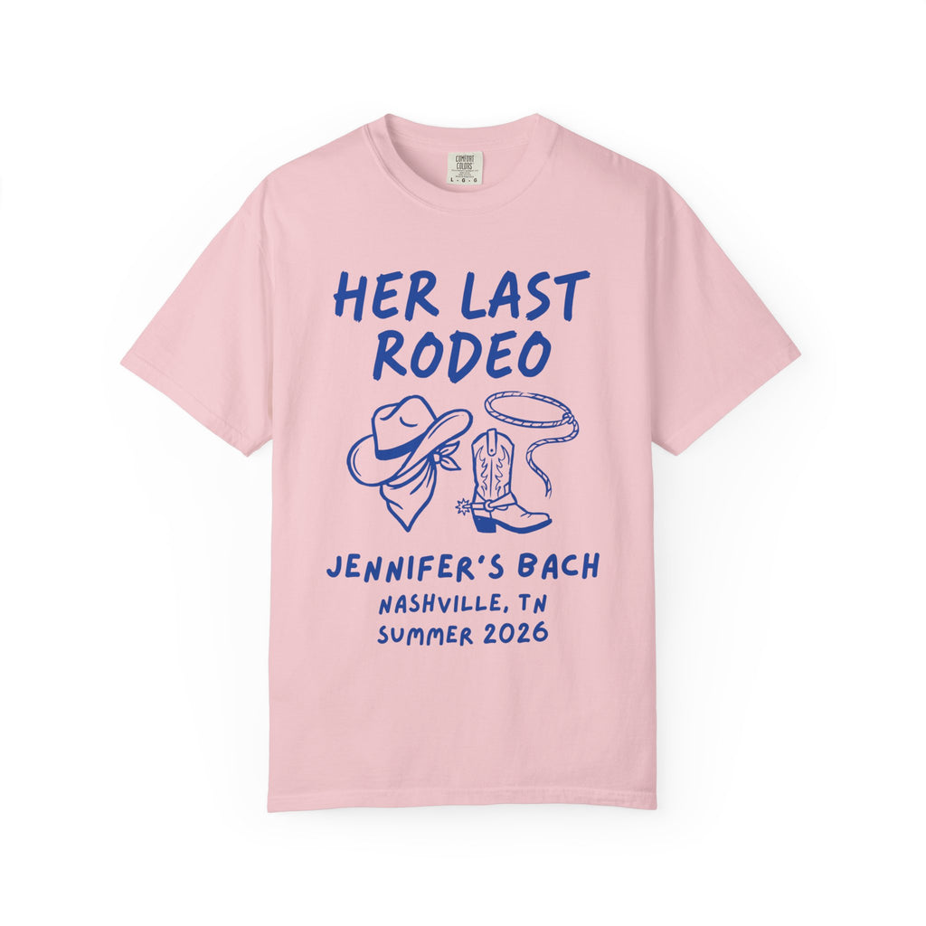 Pink t-shirt with "HER LAST RODEO" graphic, cowboy hat, rope, and boots.