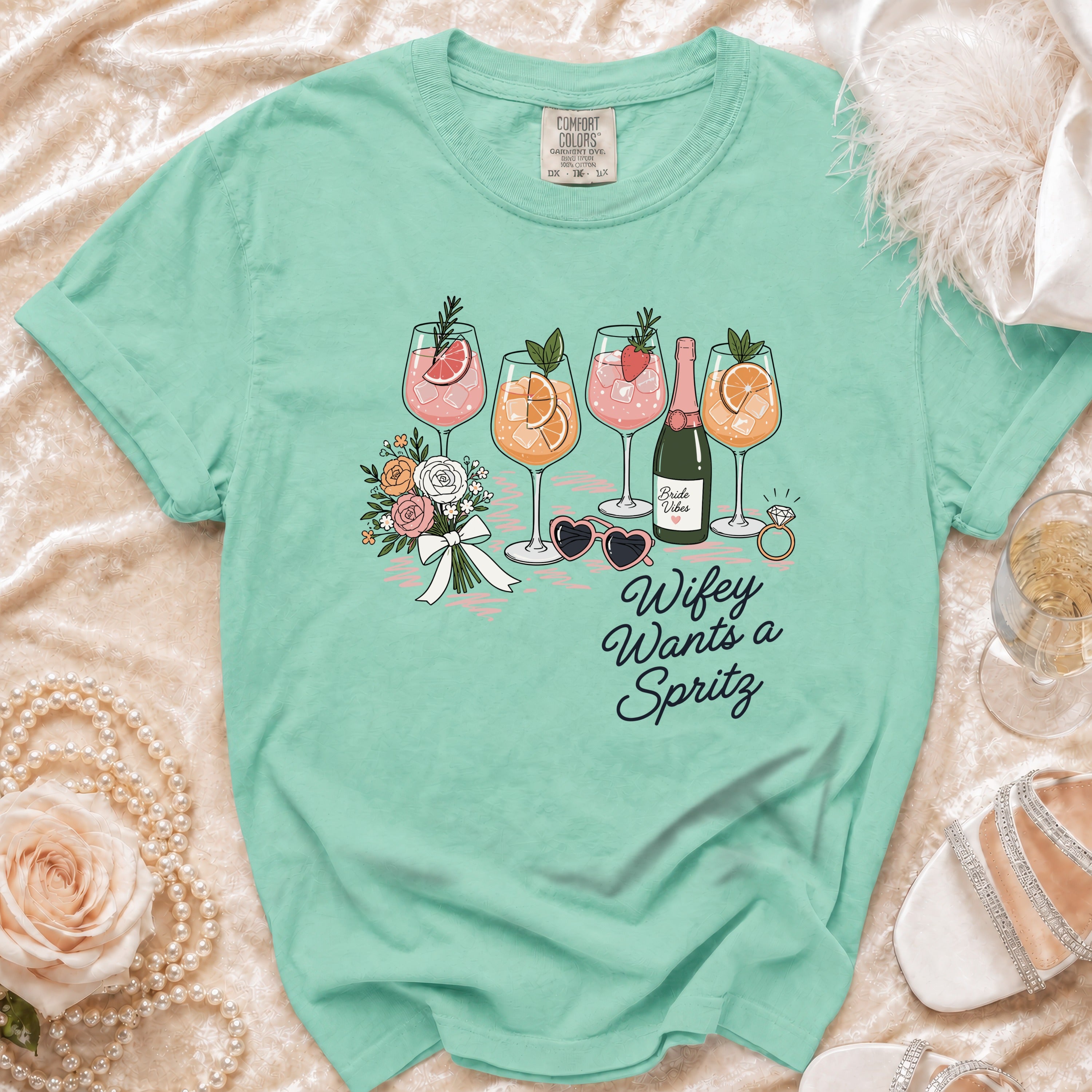 Aqua t-shirt with "Wifey Wants a Spritz" graphic featuring drinks and flowers.