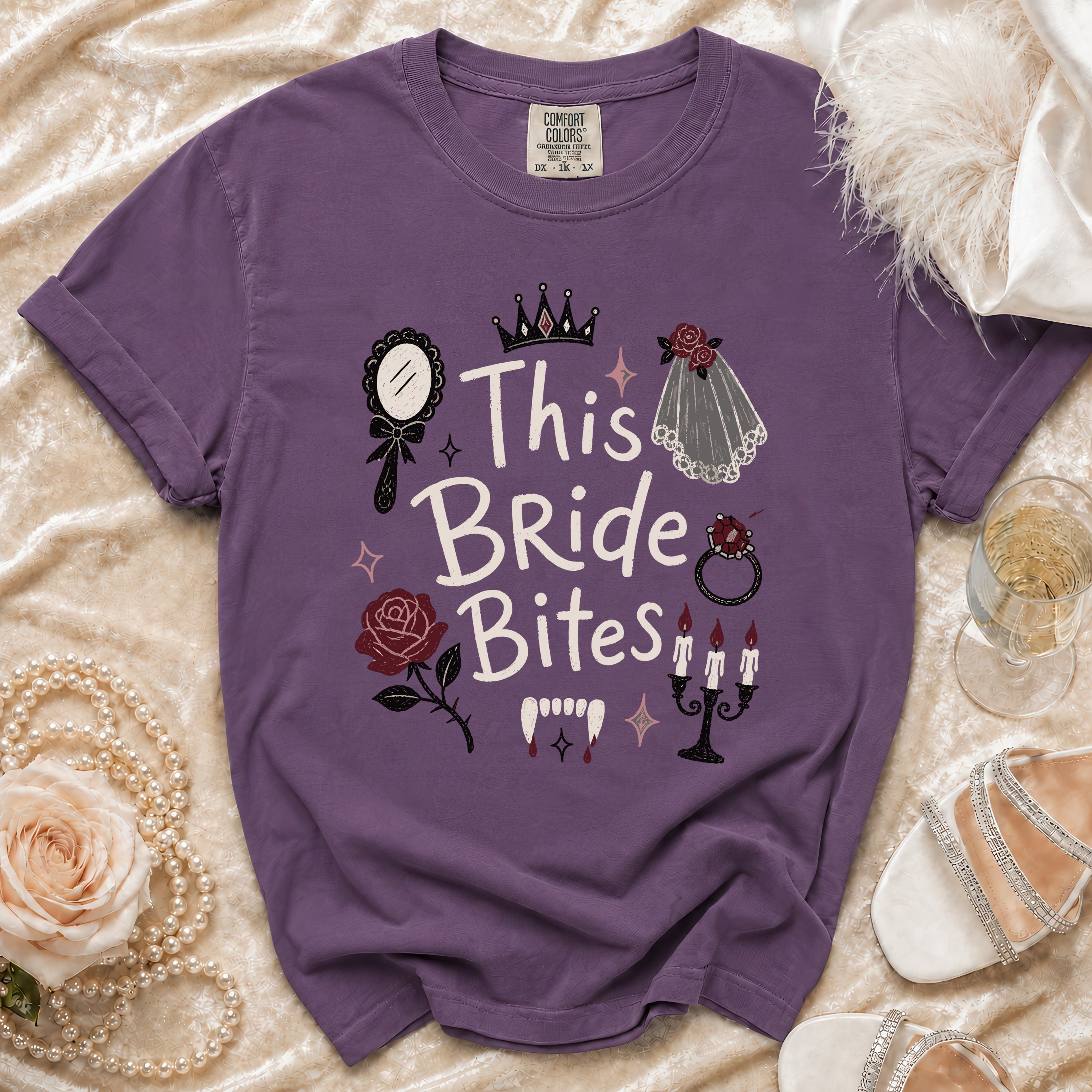 Purple t-shirt with "This Bride Bites" text and vampire graphics.