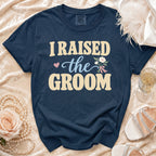 Navy blue t-shirt with "I Raised the Groom" text and floral design.