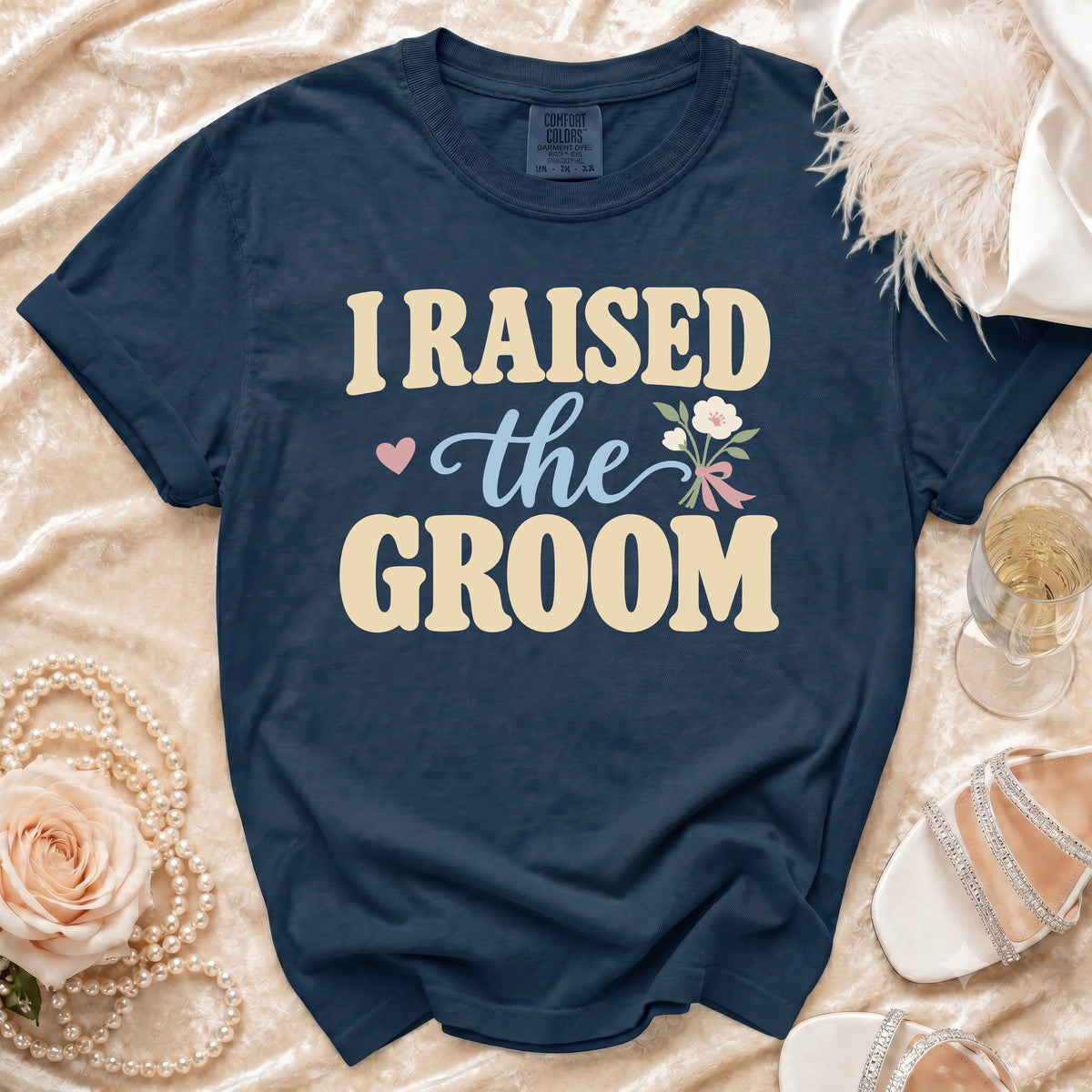 Navy blue t-shirt with "I Raised the Groom" text and floral design.