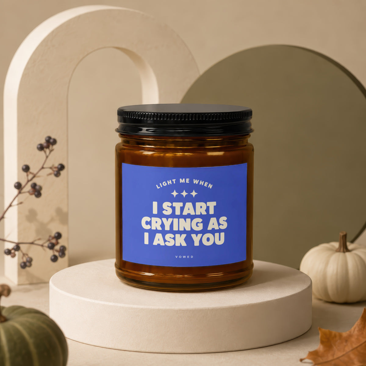 Brown glass candle with blue label reading "LIGHT ME WHEN I START CRYING AS I ASK YOU".