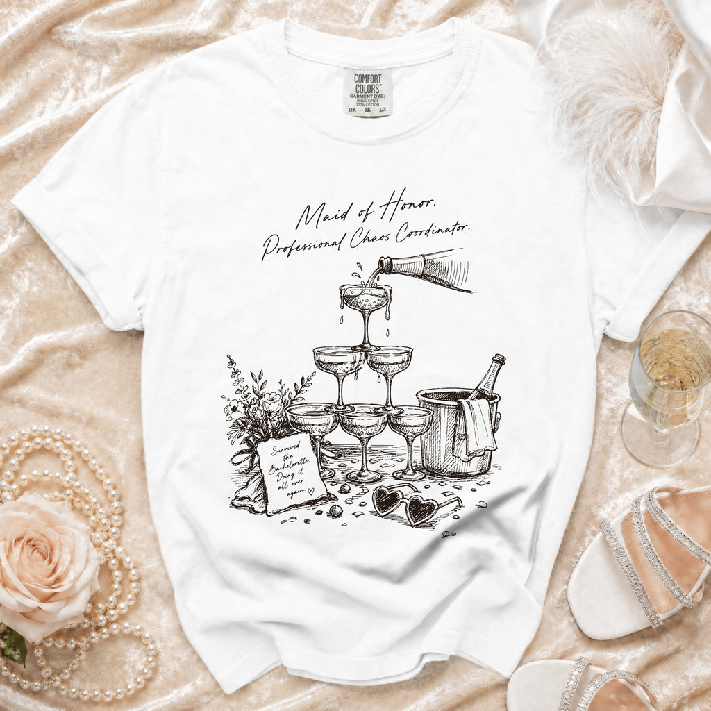 T-shirt with "Maid of Honor. Professional Chaos Coordinator." text and champagne graphic.