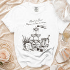 T-shirt with "Maid of Honor. Professional Chaos Coordinator." text and champagne graphic.