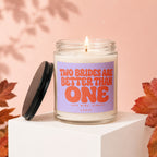 Glass candle with lavender label reading "TWO BRIDES ARE BETTER THAN ONE, LOVE WINS, ALWAYS VOWED".