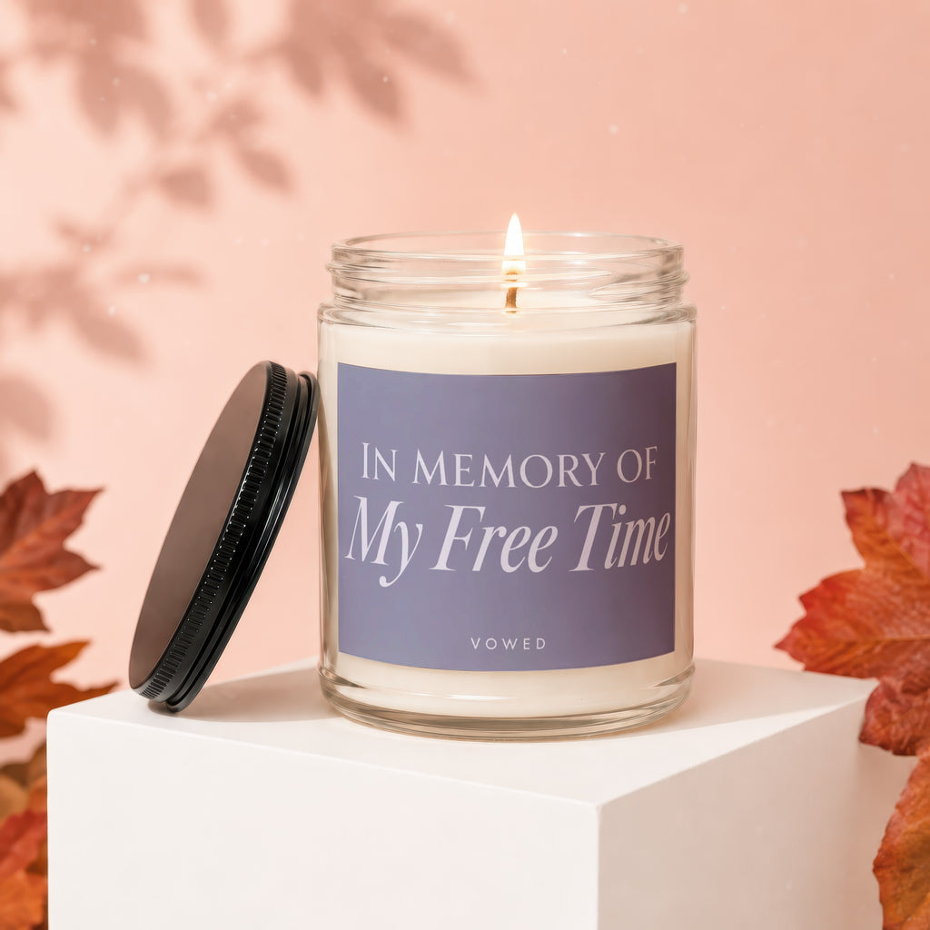 Scented candle with "In Memory of My Free Time" text on label.
