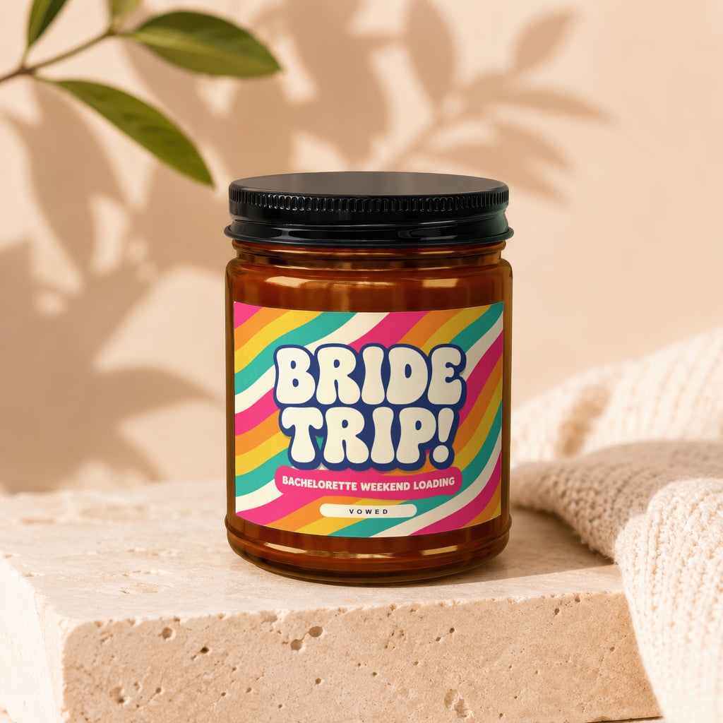 Amber candle jar with a "BRIDE TRIP! BACHELORETTE WEEKEND LOADING" label, Vowed.