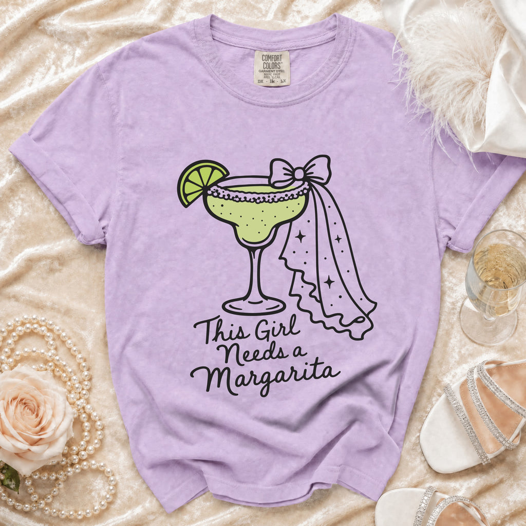 Lavender t-shirt with a margarita graphic and "This Girl Needs a Margarita" text.