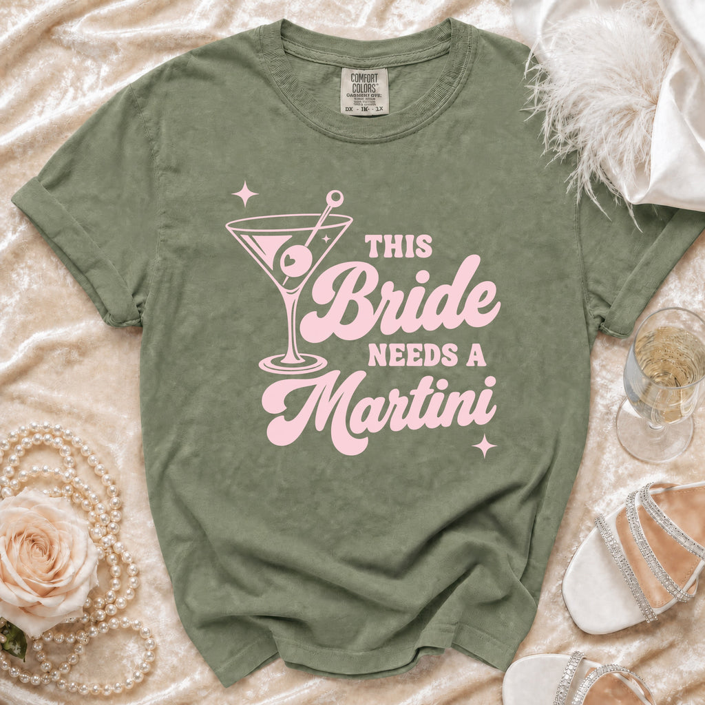 Green t-shirt with pink text reading "This Bride Needs A Martini" and a martini glass graphic.