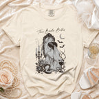 Cream t-shirt with "This Bride Bites" graphic of a bride at a mirror.