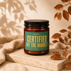 Amber jar candle with green label reading "NOTICE: CERTIFIED OFF THE MARKET"