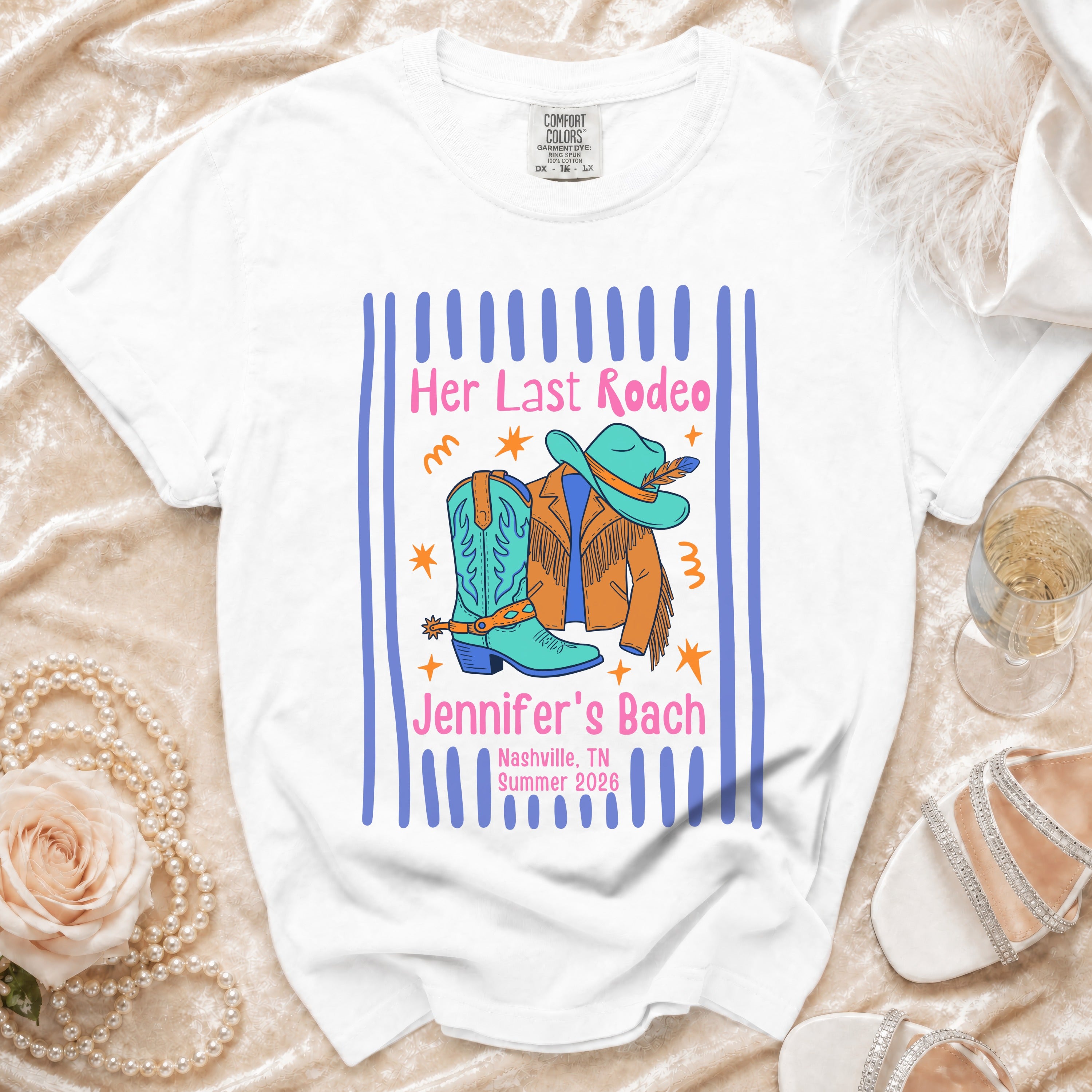 White t-shirt with "Her Last Rodeo Jennifer's Bach" text, cowboy boots, and hat.