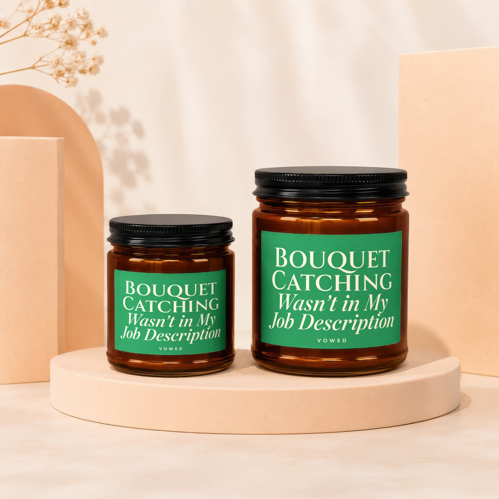 Two glass candles with green labels reading "Bouquet Catching Wasn't in My Job Description."