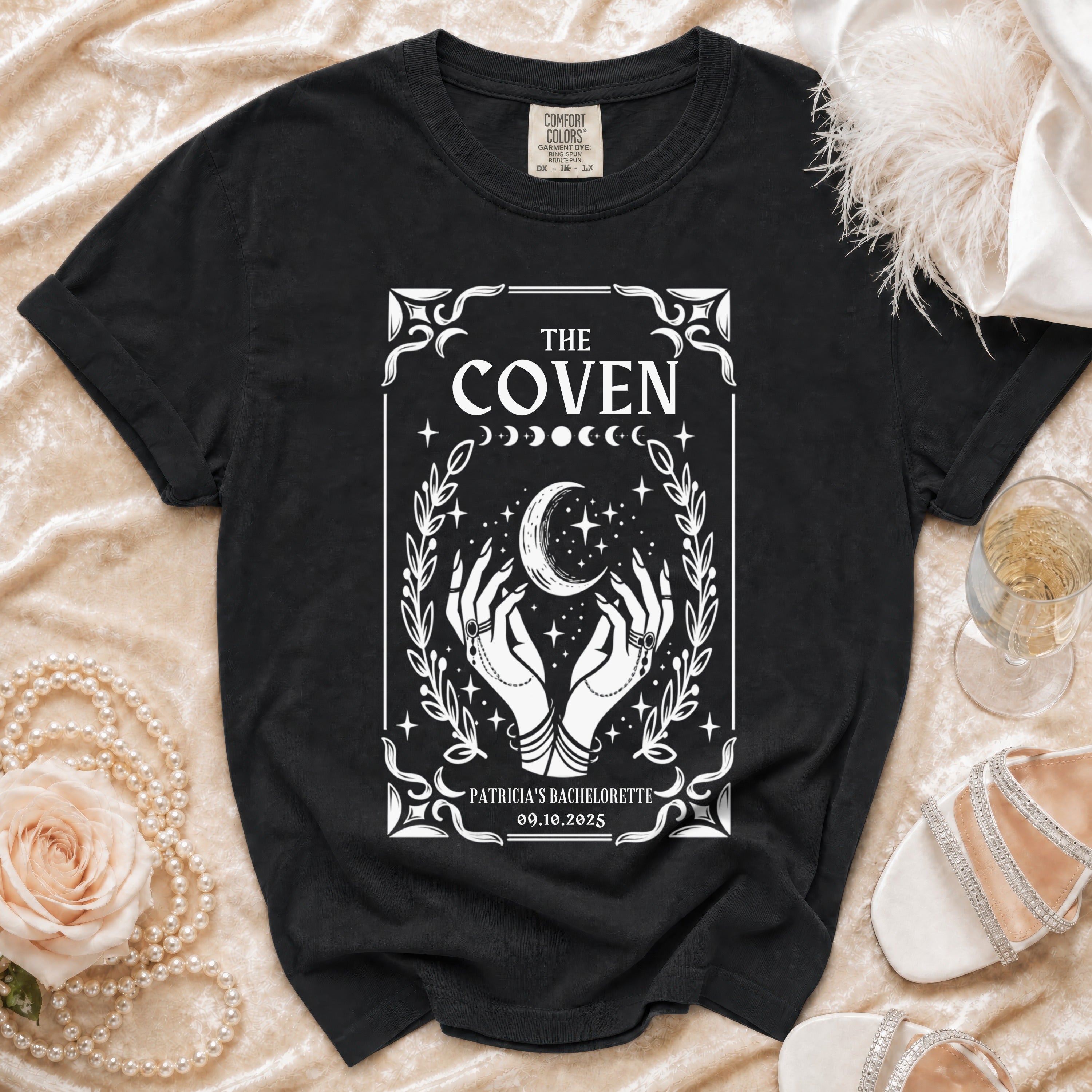 Black t-shirt with "The Coven Patricia's Bachelorette" text and celestial graphic.