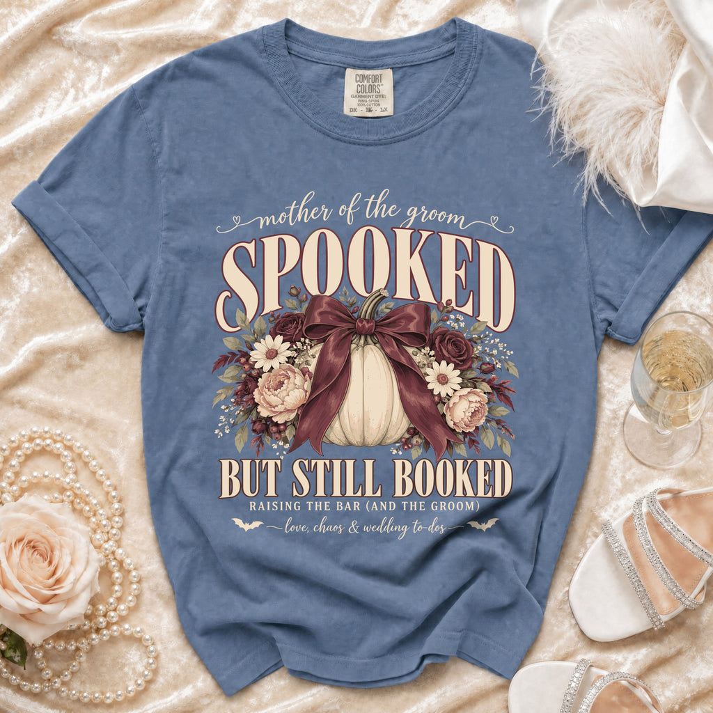 "Mother of the Groom Spooked But Still Booked" text on a blue t-shirt.