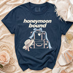Navy t-shirt with "honeymoon bound" text and stacked suitcases graphic.