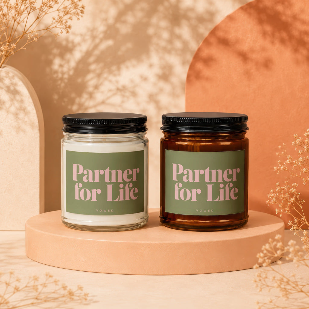 Two candles labeled "Partner for Life" by VOWED sit on pedestals.