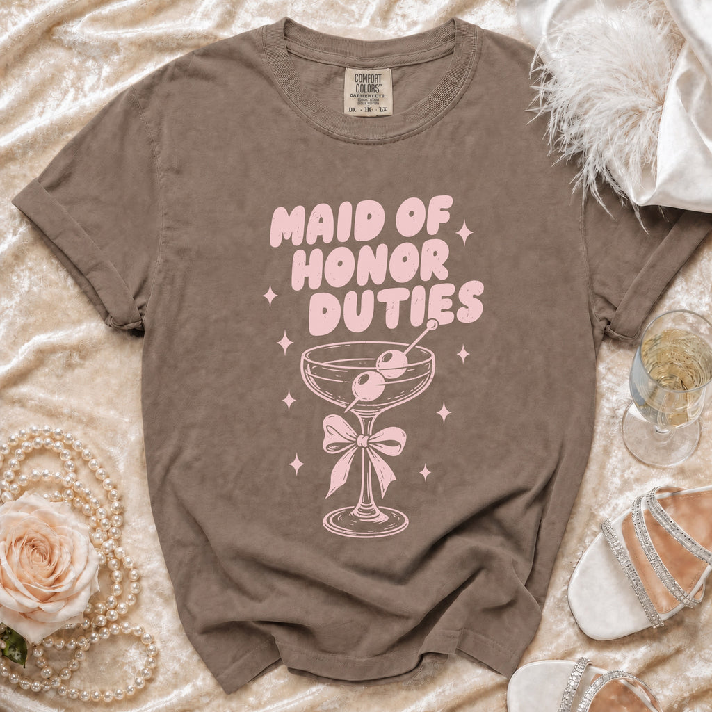 T-shirt with pink "Maid of Honor Duties" text and martini glass graphic.