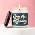Glass candle with a blue label that reads "Gay Ass Wedding Vowed."
