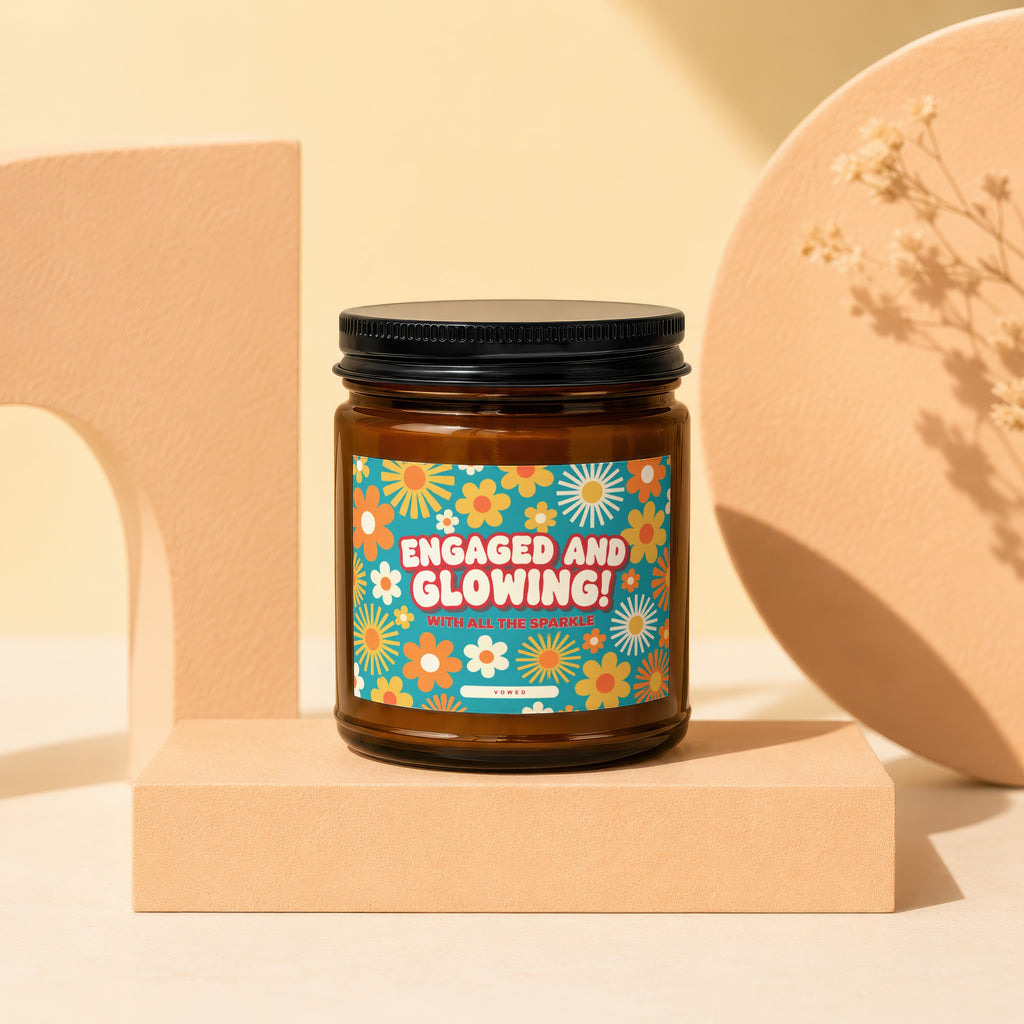 Candle labeled "Engaged and Glowing!" with floral design on blue background.