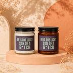 Two candles, one white and one amber, labeled "He is one lucky son of a b*tch".