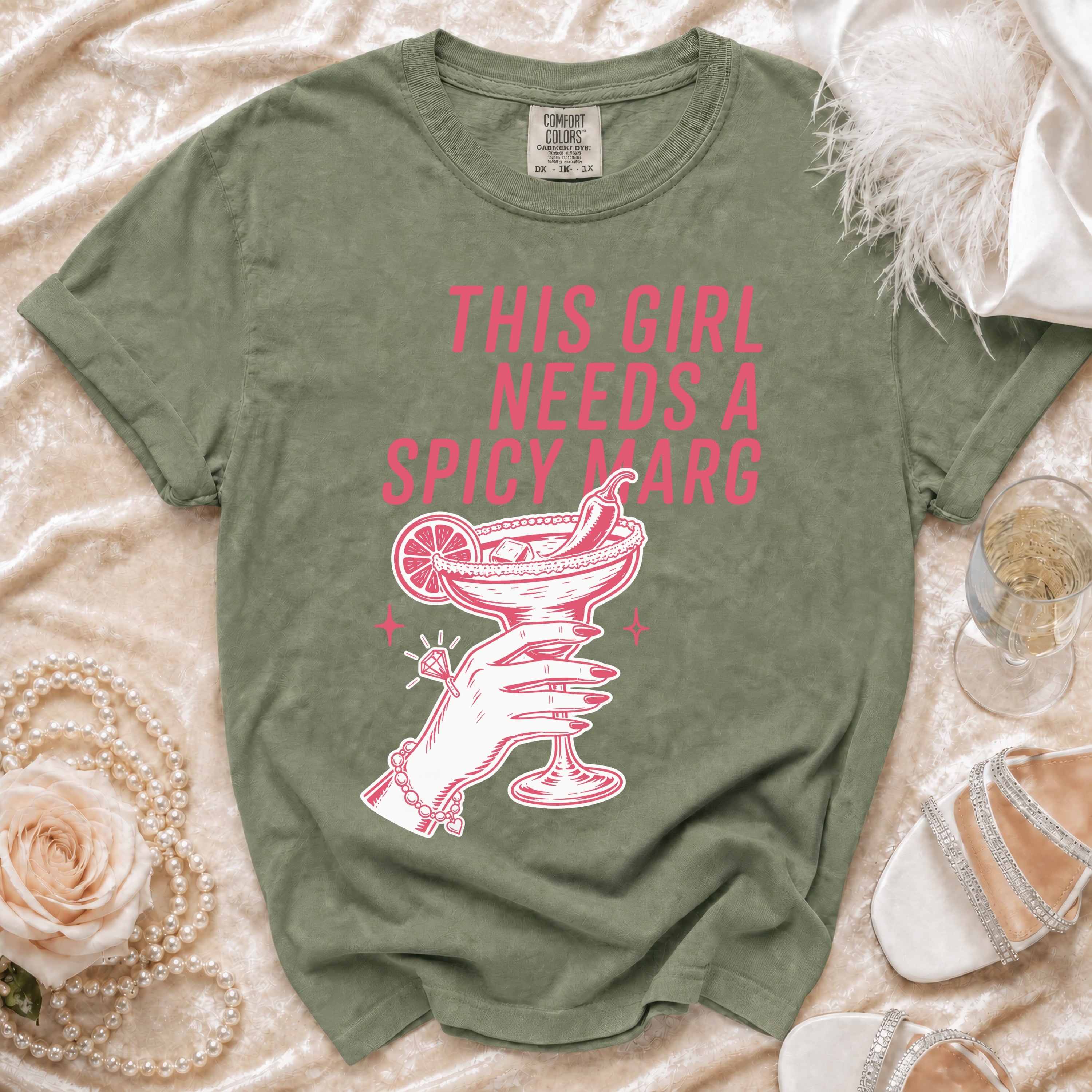 Green t-shirt with graphic "This girl needs a spicy marg" and margarita.