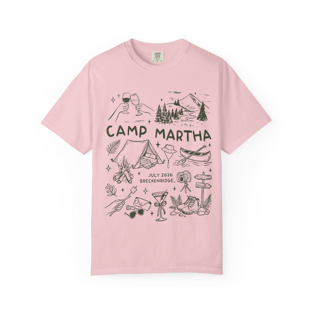 Pink t-shirt with Camp Martha logo featuring outdoor illustrations and event details.