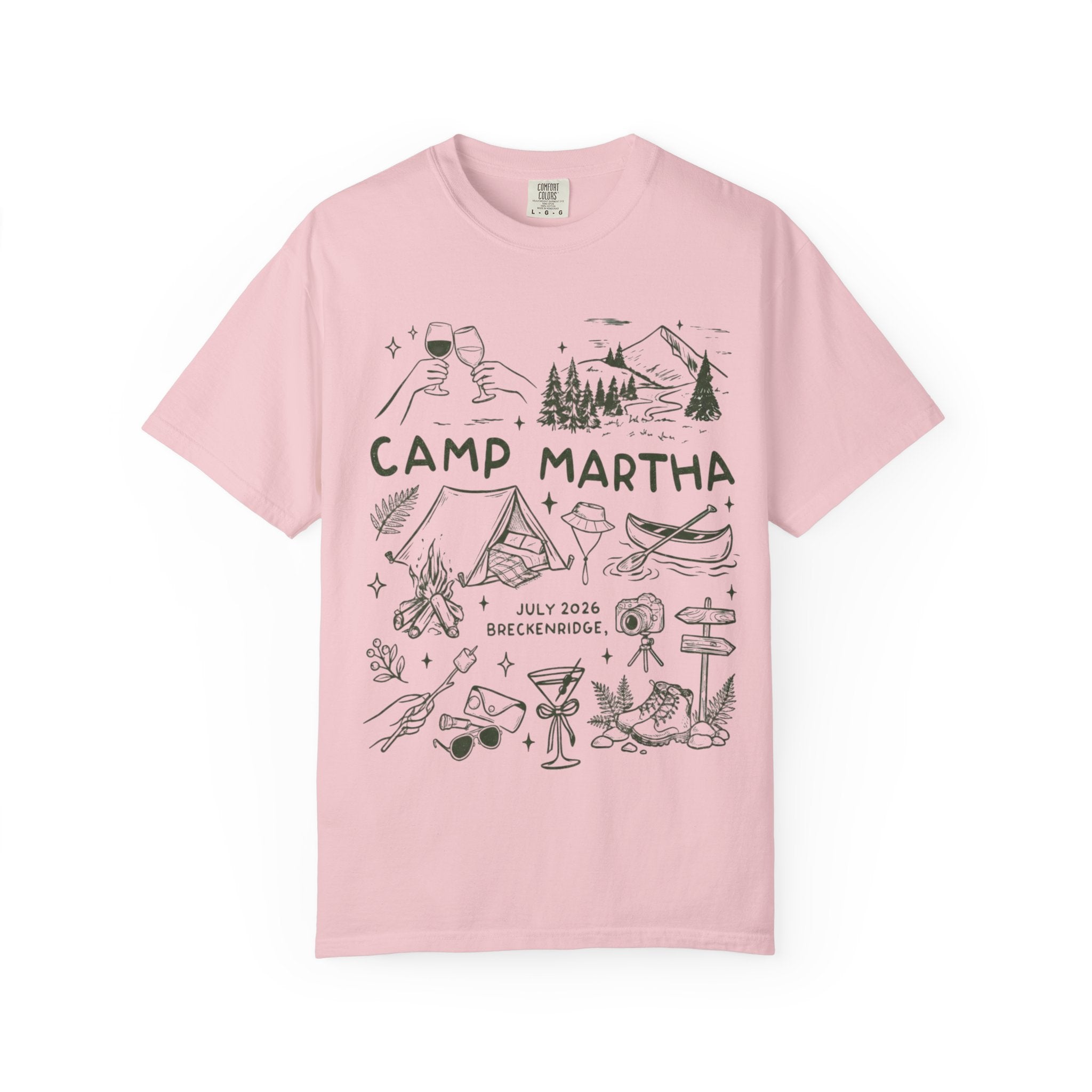 Pink t-shirt with Camp Martha logo featuring outdoor illustrations and event details.