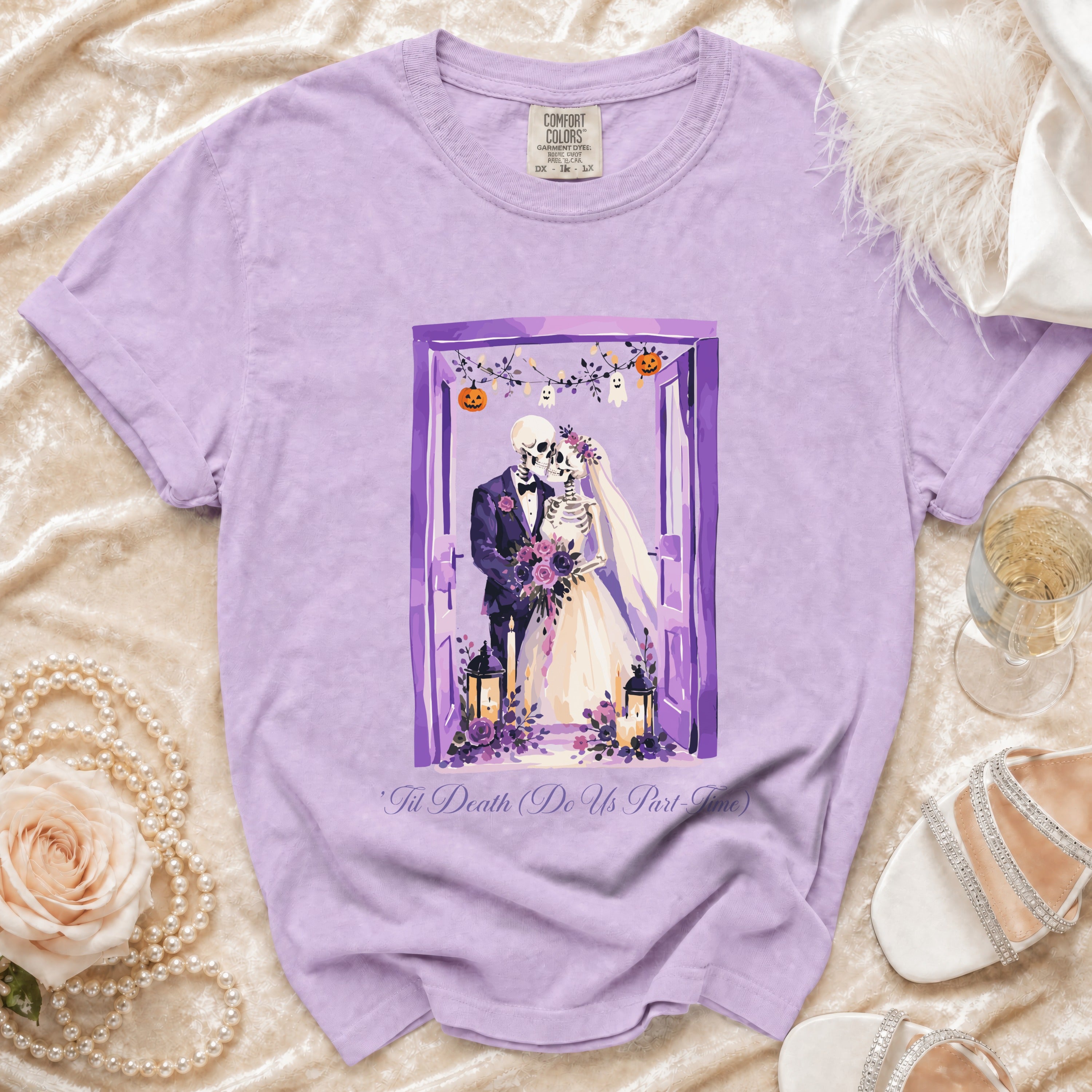 Purple t-shirt with skeleton bride and groom graphic and text.