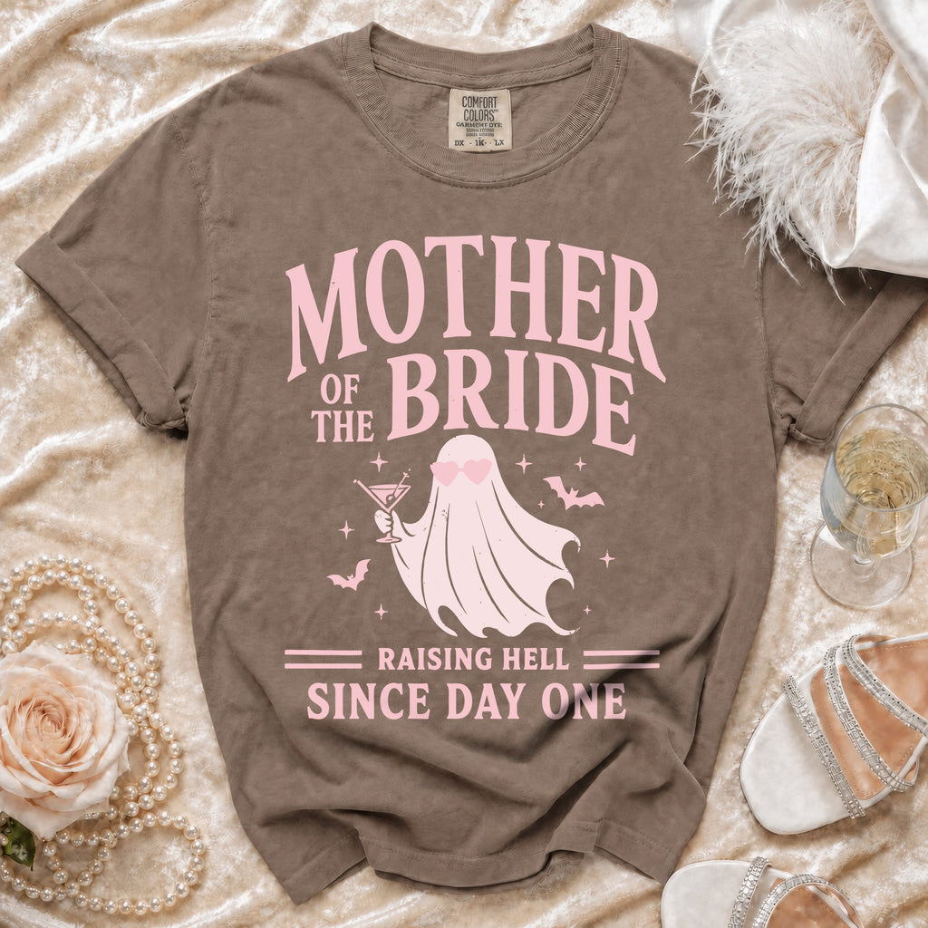 Brown t-shirt with "Mother of the Bride Raising Hell Since Day One" text and ghost graphic.