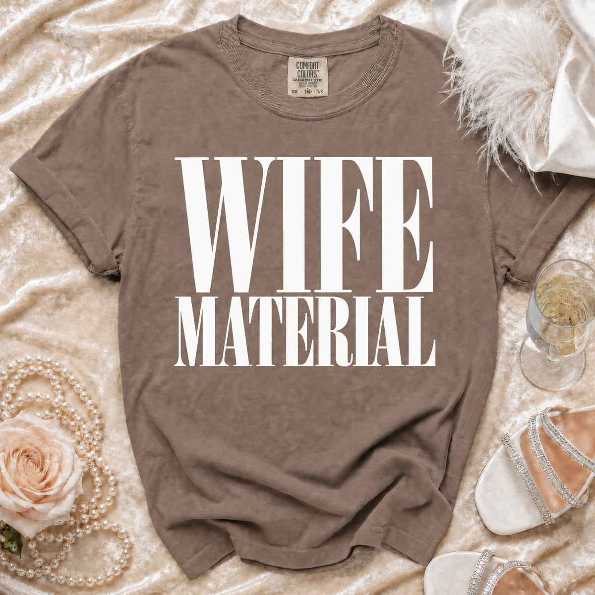 Brown t-shirt with white text that reads "WIFE MATERIAL"