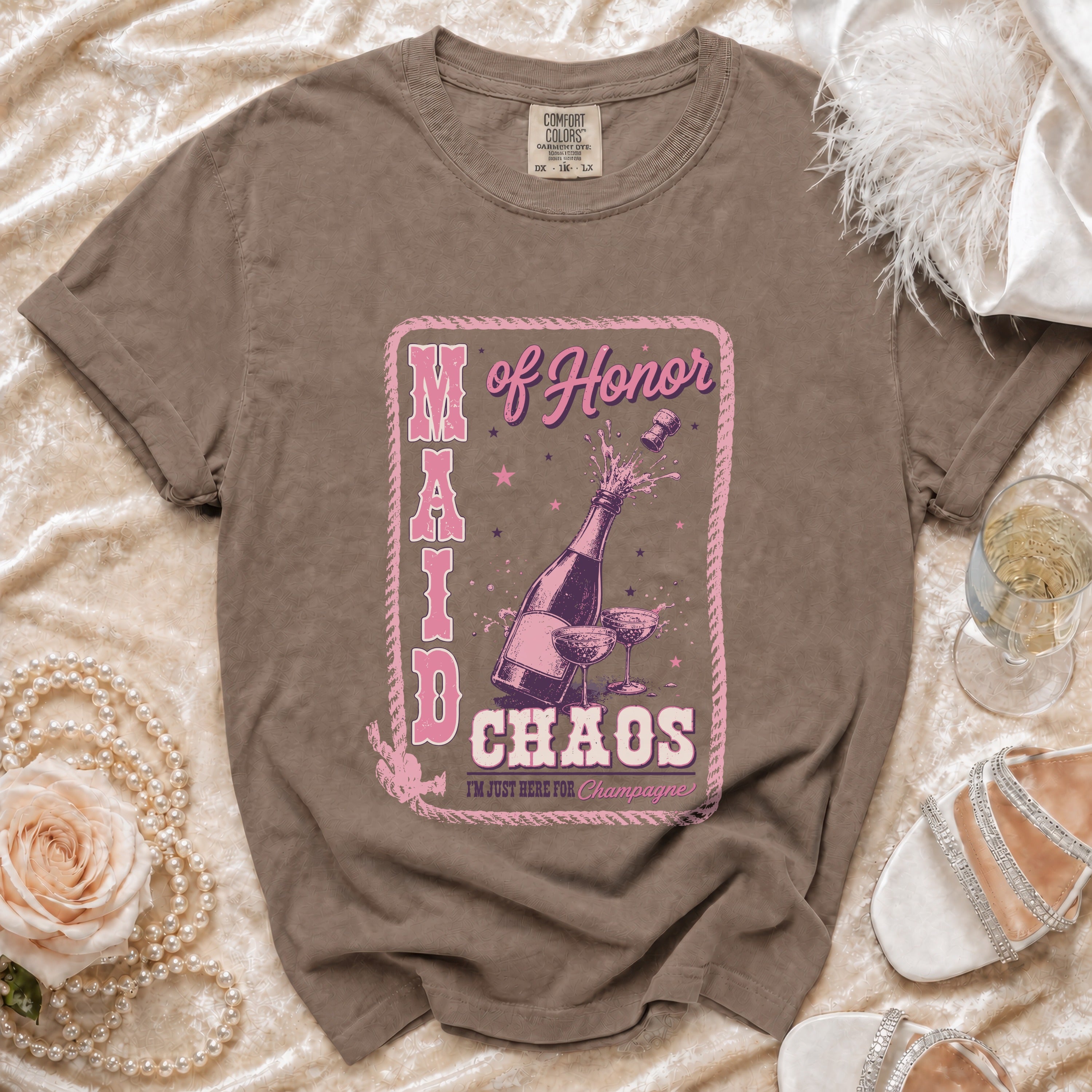 Brown t-shirt with "Maid of Honor" text and champagne bottle graphic.