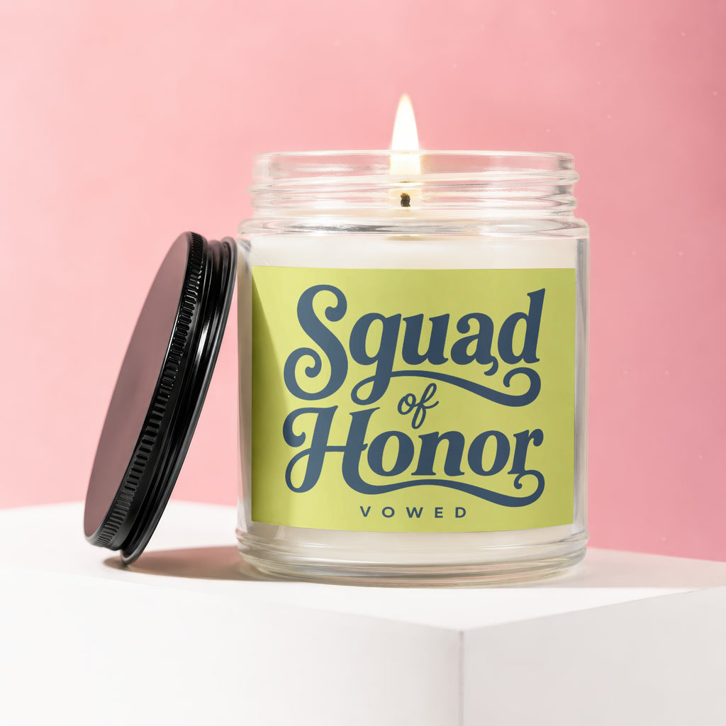 Glass candle with "Squad of Honor vowed" text on a light green label.