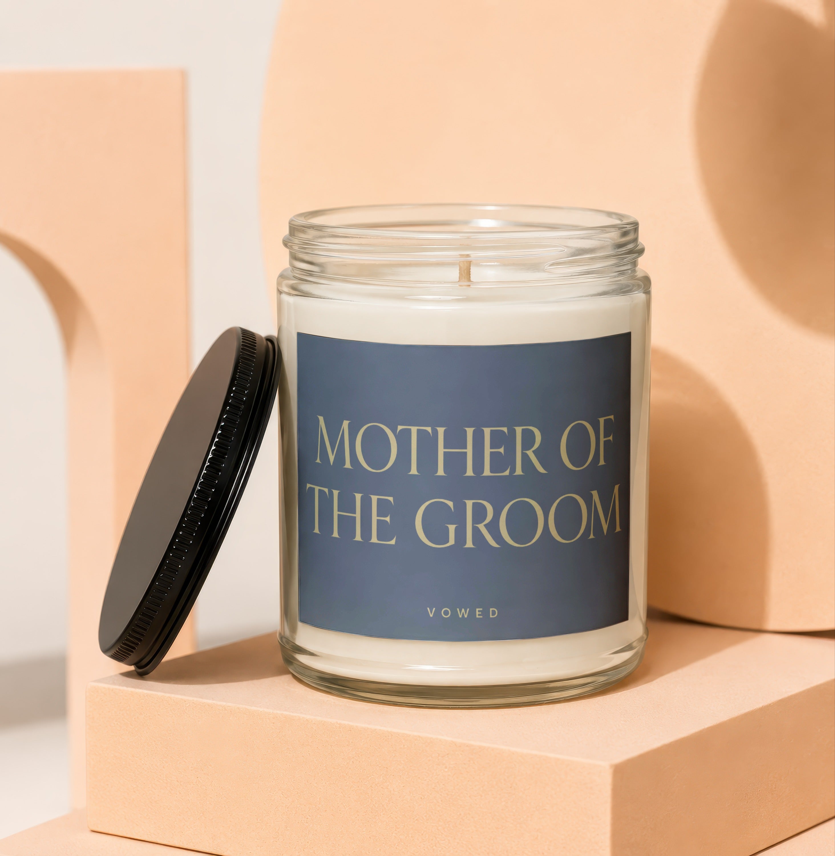 Glass candle with "Mother of the Groom" and "VOWED" on label.