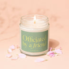 Lit candle in a jar with label text "Officiated by a friend" and "vowed".