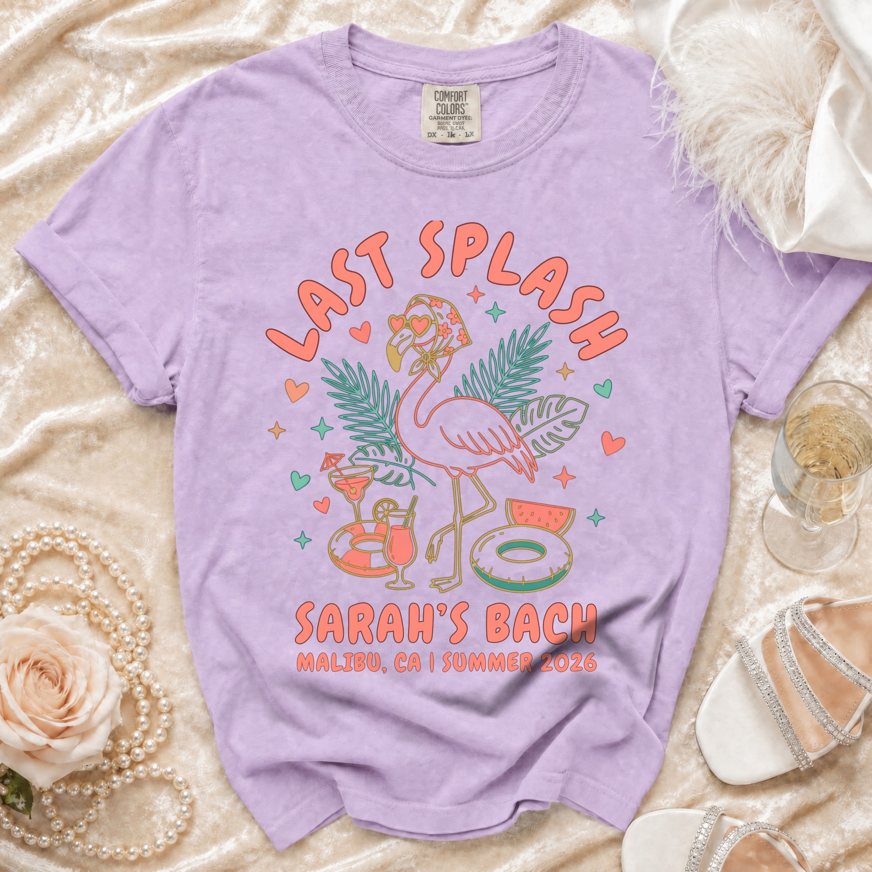 Lilac t-shirt with "Last Splash Sarah's Bach Malibu CA Summer 2026" text and graphics.