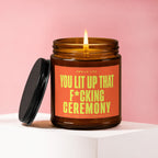 Amber jar candle with a lit wick, reads "You Lit Up That F*cking Ceremony".