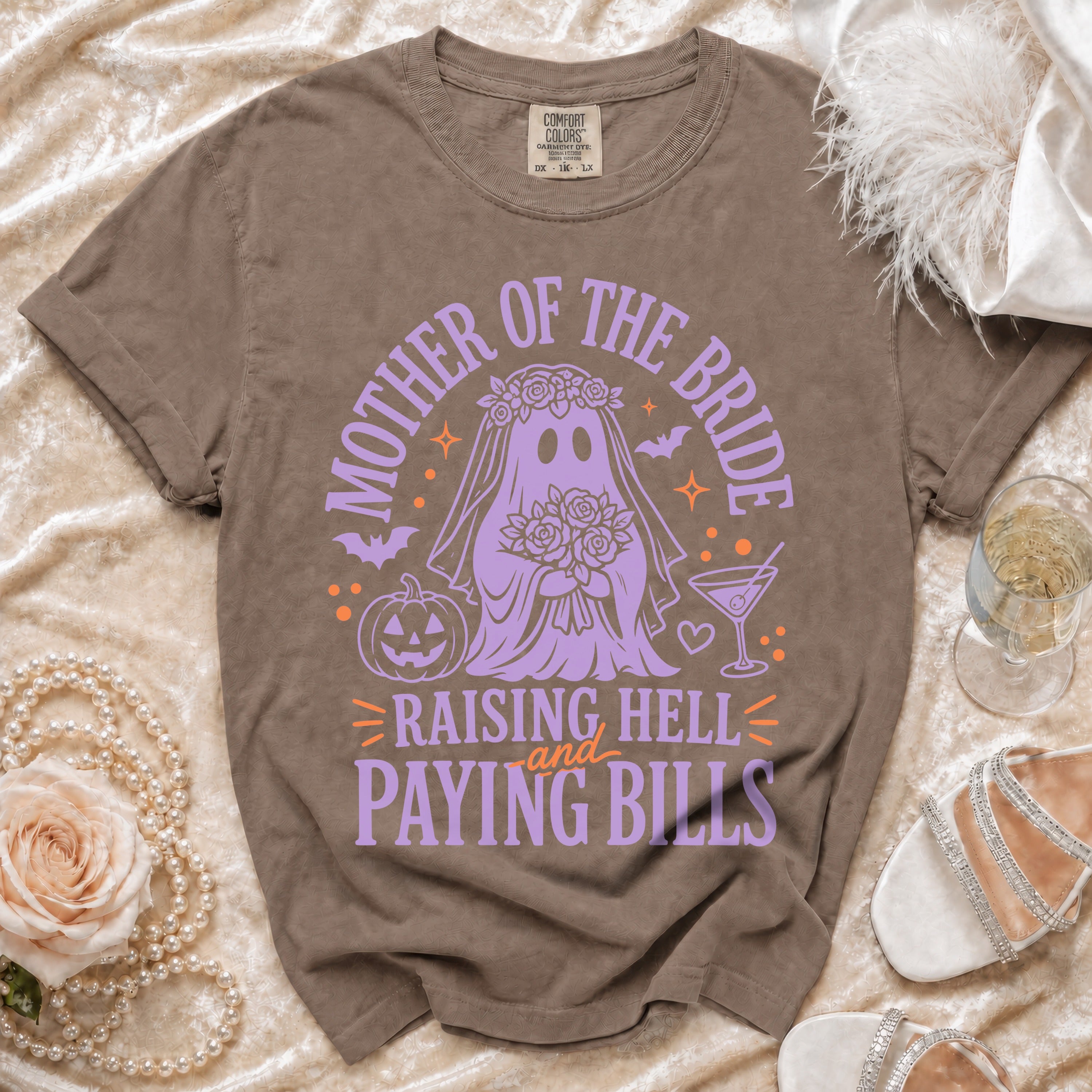 T-shirt with purple ghost bride graphic saying "Mother of the Bride Raising Hell and Paying Bills".