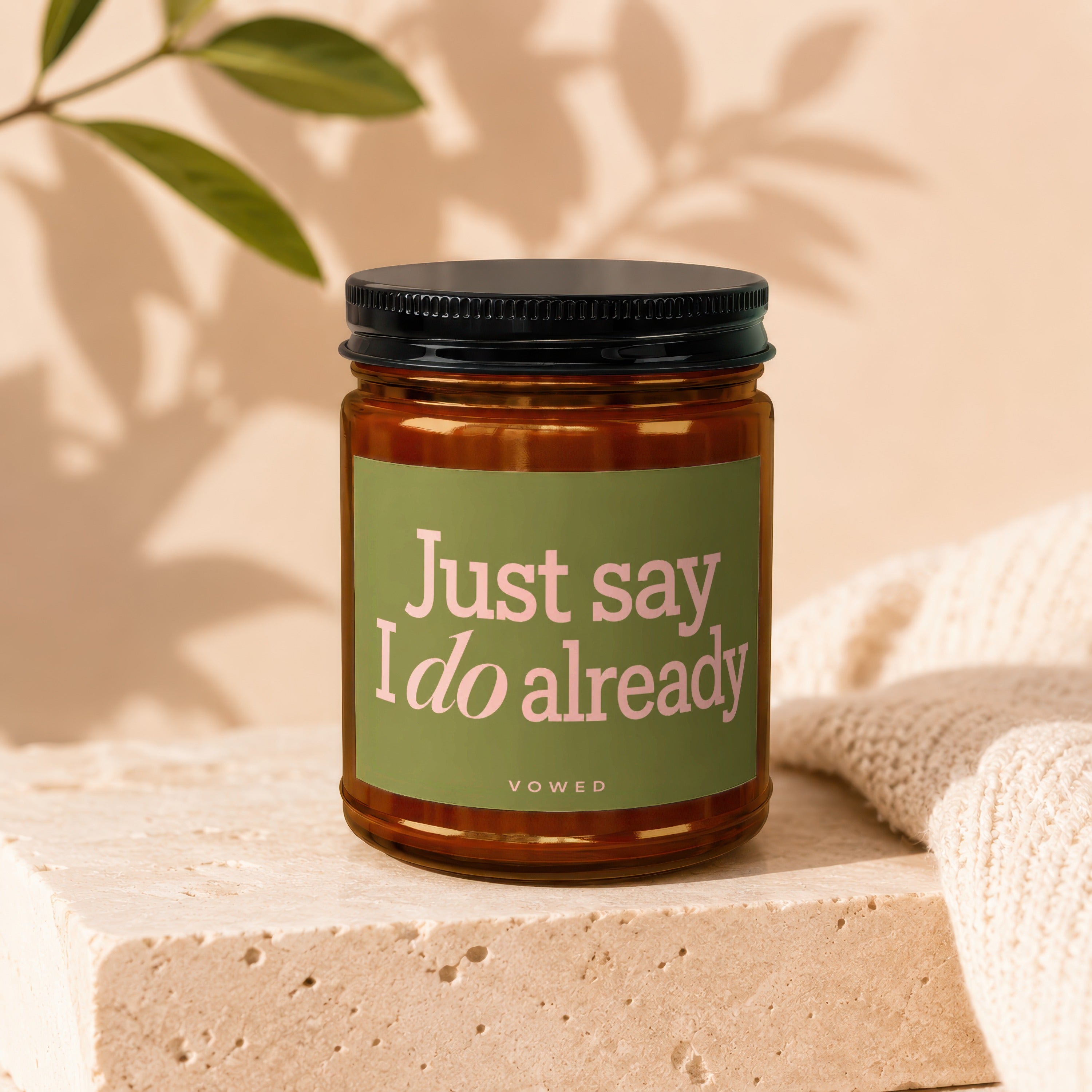 Candle with "Just say I do already" text on an olive green label.