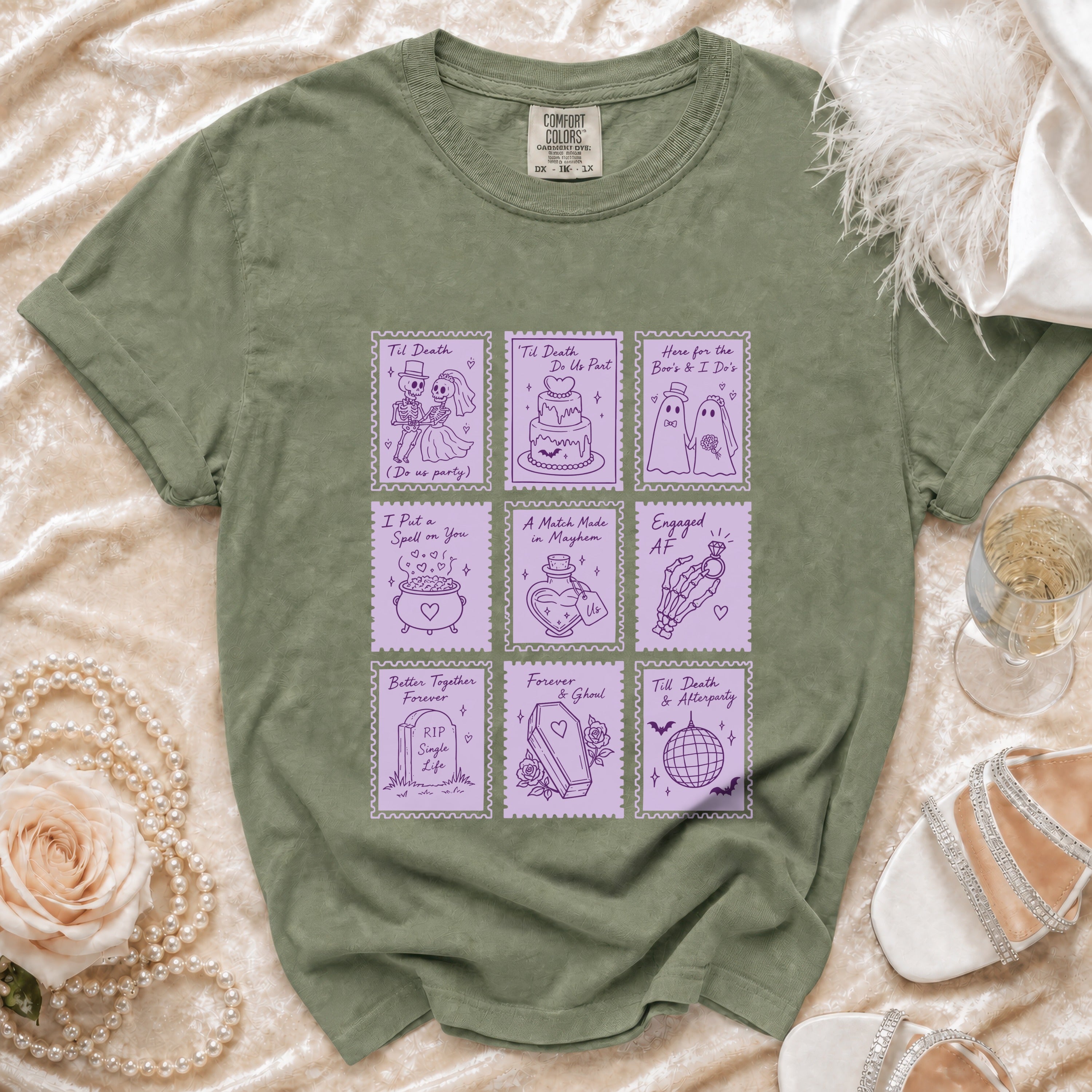 Green t-shirt with purple graphic of nine stamps with wedding and spooky themes.