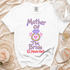 White t-shirt with "Mother Of The Bride (I Made Her)" graphic and ring design.