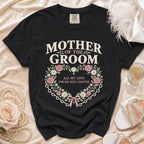 Black t-shirt with "Mother of the Groom" text and floral heart design.