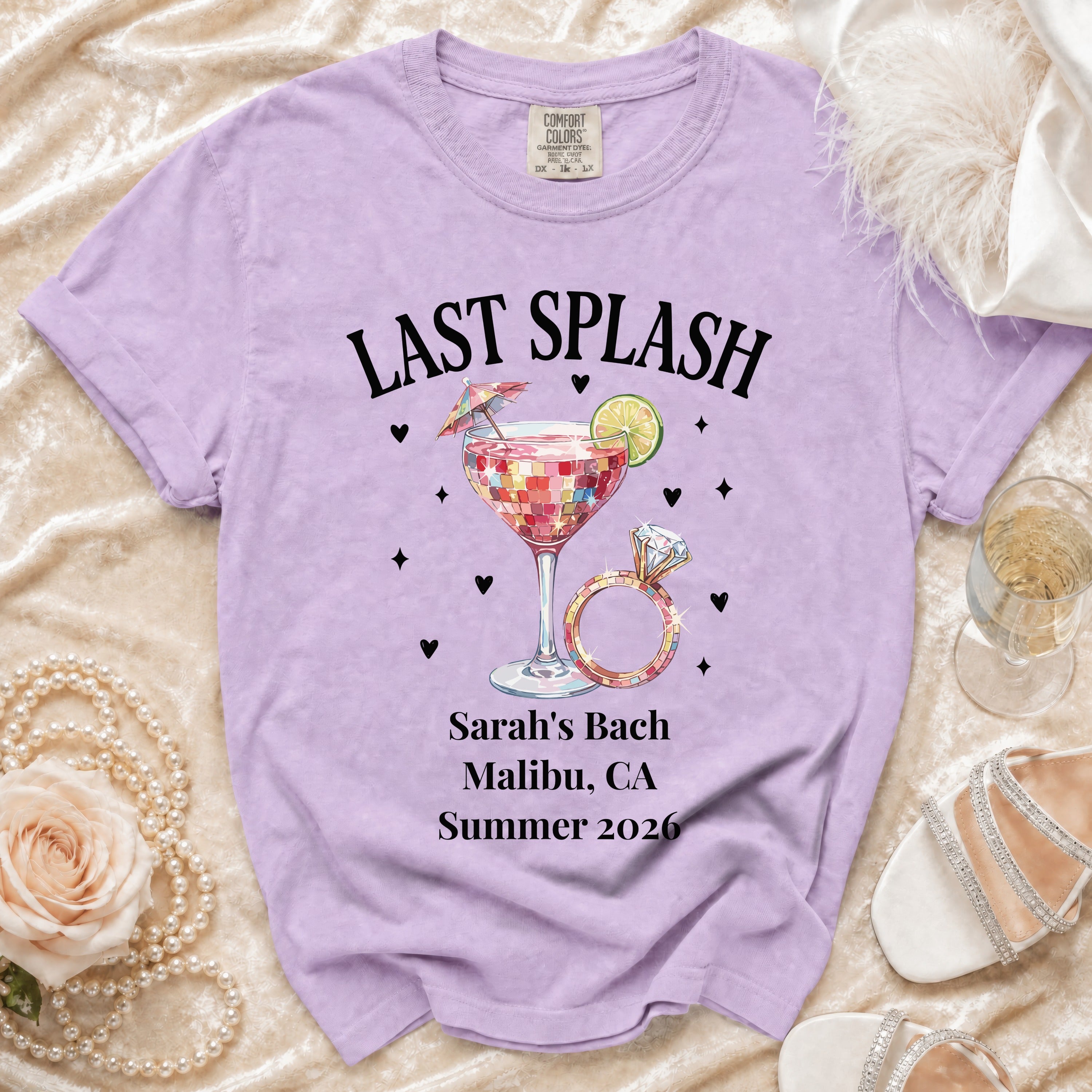 Purple t-shirt with "Last Splash" text, ring, cocktail, and bachelorette party details.