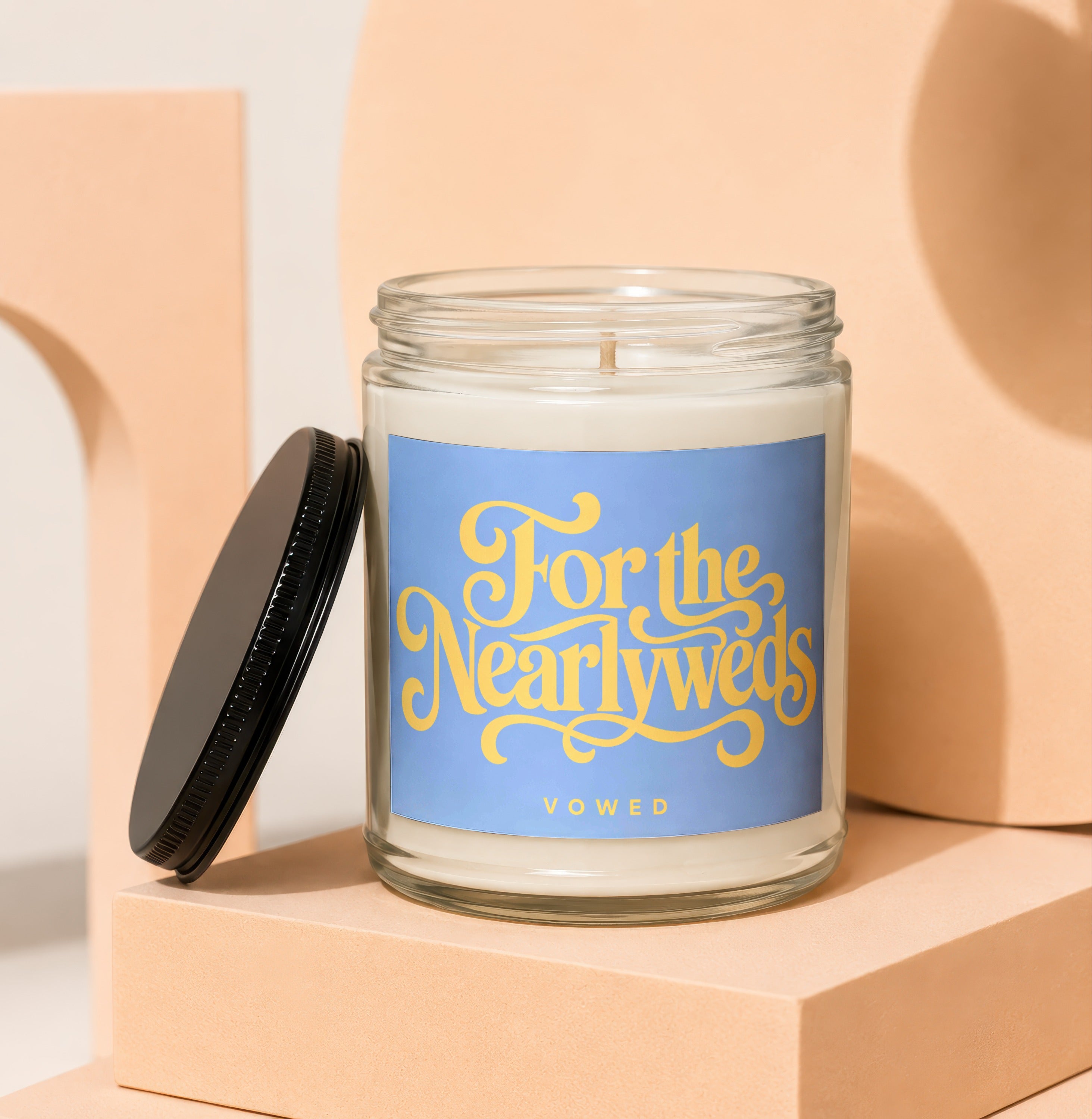 Candle with a lavender label that reads "For the Newlyweds" and "VOWED."