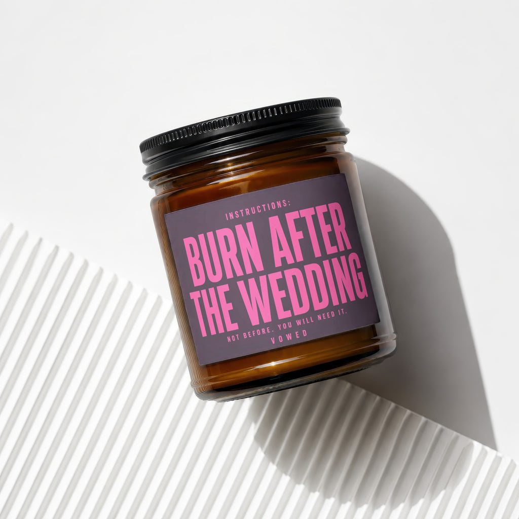 Brown candle in a jar with a label that reads "BURN AFTER THE WEDDING."